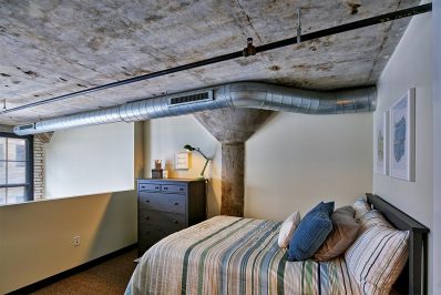 Image Of A Bedroom Inside A Loft Apartment With A Bed