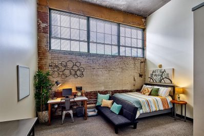 Image Of A Bed Inside Of A Loft Apartment