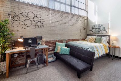 Image Of A Bedroom With A Bed And Desk